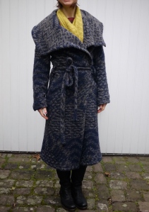 Coat worn with hand-knitted cowl from